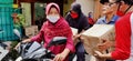 Jakarta, Indonesia - 06172020: Two women carry goods on the motorbike