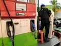 JakartVehicle refueling handle with a background of a worker operating a computer