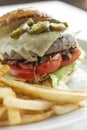 Jalapeno cheese burger with french fries on restaurant table