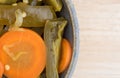 Jalapeno peppers and carrots in a bowl on wood table Royalty Free Stock Photo