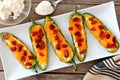 Jalapeno poppers with cheese and pepperoni on a white plate Royalty Free Stock Photo