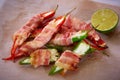 Jalapeno poppers wrapped in bacon stuffed with cheese seasoned with herbs and spices, top view. Shallow dof.