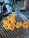 Jalebi, yellow jalebi is a famous indian sweet. This shows how jalebi are 1st fried in oil