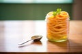 jalebi in a glass jar, focus on coiled patterns