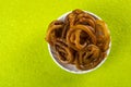 Jalebi Indian sweet dish on green background