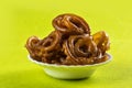 Jalebi Indian sweet dish on green background