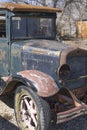 Jalopy car truck with front wheel, headlight, radiator, windshield shows another past era of transportation. Royalty Free Stock Photo