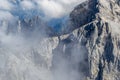 Jalovec mountain ridge in Slovenian Julian Alps, Triglav National Park, partially covered in clouds, during a Summer hiking trip Royalty Free Stock Photo