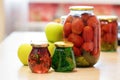 Jam of fir twigs and cones and mountain cranberries in small jars