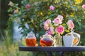 Jam in glass jar. Romantic dinner in the garden under a rose bush. Royalty Free Stock Photo