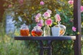 Jam in glass jar. Romantic dinner in the garden under a rose bush. Royalty Free Stock Photo