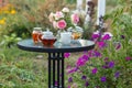 Jam in glass jar. Romantic dinner in the garden under a rose bush. Royalty Free Stock Photo