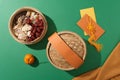 Jam, salted dried fruit, jujube, gummy candy are contained in a bamboo steamer, tangerine and red envelopes on a green background Royalty Free Stock Photo