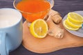 Jam with sea buckthorn juice with ginger and lemon on a wooden background. Conceptual autumn vitamin drink to enhance health and Royalty Free Stock Photo