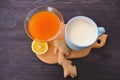 Jam with sea buckthorn juice with ginger and lemon on a wooden background. Conceptual autumn vitamin drink to enhance health and