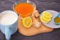 Jam with sea buckthorn juice with ginger and lemon on a wooden background. Conceptual autumn vitamin drink to enhance health and
