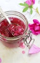 Jam of tea rose petal in glass jar on light marble background. Flower confiture. Healthy food. Copy space Royalty Free Stock Photo