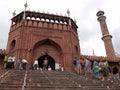 Many people on the stairs of the main access gate to the Jama Masjid Mosque in New Delhi, India