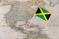 Jamaica flag pin on world map Royalty Free Stock Photo