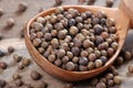 Jamaica pepper in a wooden spoon. traditional spices. allspice close-up. selective focus