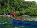 Jamaican fisherman paddling on a boat Royalty Free Stock Photo