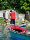 Jamaican fisherman paddling on a boat Royalty Free Stock Photo