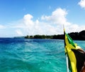 Jamaican Flag trailing boat in the Ocean