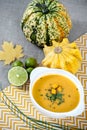 Jamaican pumpkin soup with lime in a white stylish plate.