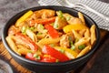 Jamaican Rasta Pasta tossed in Jamaican jerk seasoning, chicken, coconut milk and with colourful sauteed bell peppers closeup on Royalty Free Stock Photo