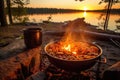 jambalaya cooking in pot on campfire, sun setting