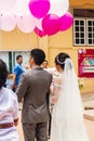 Jambi, Indonesia - October 7, 2018 : Chinese wedding couple shot from the back at Vihara Satyakirti