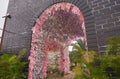 Jambi, Indonesia - September 2019. an replica of fortress building with a pink of flower gate in jambi