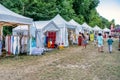 03.08.2022 - Jambville, France: Market at yoga festival, vintage stuff, flea market, yoga supplies, white tents.