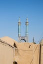 Jameh mosque, with its distinctive tiles minarets, seen from a nearby street. Jameh mosque is one of the symbols of Yazd