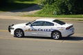 A police car stopped in the middle of the road to patrol the street Royalty Free Stock Photo