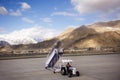 JAMMU KASHMIR, INDIA - MARCH 19 : Indian and tibetan crew prepare stairs for passengers walking out of plane of Kushok Bakula