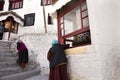 Tibetan pilgrim people walk on stone stairs step up approach to Diskit Monastery Galdan Tashi Chuling Gompa at Leh Ladak