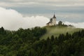 Jamnik church on a hillside in the spring, foggy weather at sunset in Slovenia, Europe. Mountain landscape shortly after spring ra Royalty Free Stock Photo