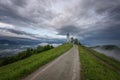 Jamnik church on a hillside in the spring, foggy weather at sunset in Slovenia, Europe. Mountain landscape shortly after spring ra Royalty Free Stock Photo