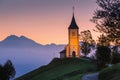 Jamnik, Slovenia, church of St. Primoz, Julian Alps at background Royalty Free Stock Photo