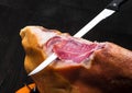 Jamon. Jamon serrano. Traditional Spanish ham on black close up. Royalty Free Stock Photo