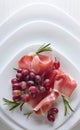 Jamon serrano with rosemary and grape . Royalty Free Stock Photo