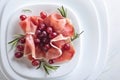 Jamon serrano with rosemary and grape . Royalty Free Stock Photo