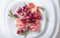 Jamon serrano with rosemary and grape Royalty Free Stock Photo