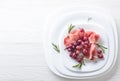 Jamon serrano with rosemary and grape . Royalty Free Stock Photo