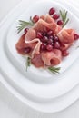 Jamon serrano with rosemary and grape . Royalty Free Stock Photo