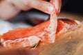 Jamon serrano. Traditional Spanish ham, Slicing of dry-cured ham in Spain Royalty Free Stock Photo