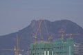 Buildings under construction in the newly developed area of ??Kowloon City against the background of the Lion Rock