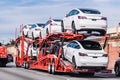 Jan 18, 2020 Palo Alto / CA / USA - Car transporter carries Tesla Model 3 new vehicles on a freeway in San Francisco bay area,