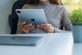 Jan 5th 2021 : A woman using Apple New Ipad Pro 2020 digital tablet with Apple MacBook Pro laptop computer on the Royalty Free Stock Photo